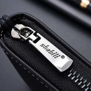 Men's long leather wallet in black featuring a smooth silver metal zipper detail