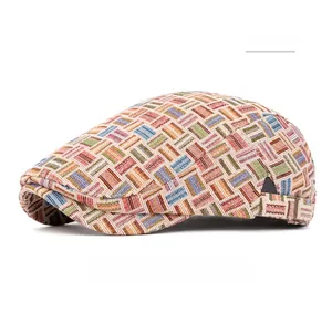 Close-up of pink multicolor woven newsboy cap showing detailed geometric pattern texture