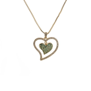 Detail of gold double heart pendant necklace with green and white cubic zirconia