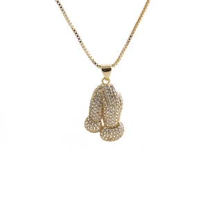 Close-up of golden boxing glove pendant with white zircons on a sturdy box chain