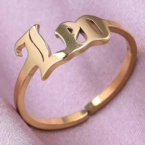 Macro shot of rose gold adjustable open ring featuring artistic 1997 year number design