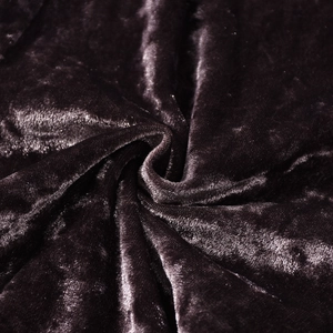 Macro detail of luxurious dark purple velvet fabric with soft folds and metallic luster