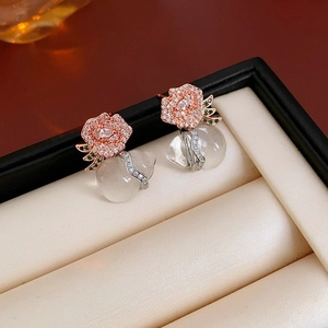 Rose gold floral pearl earrings with green leaf and pear-shaped gemstone in a box