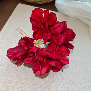 Close-up of handmade dark red fabric flower hairpin with vintage gold metal fork