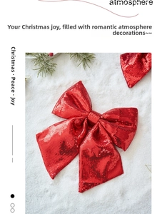 Sparkling red sequin Christmas bow decoration on white snow background with pine branch