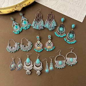 Flat lay of vintage bohemian earrings with turquoise beads and tassels in various shapes