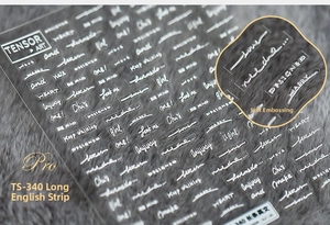 Macro shot of 5D white embossed letter nail stickers with 3D relief texture on grey fur