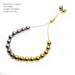 Adjustable copper ball bead bracelet with gold and silver spheres in 8mm diameter