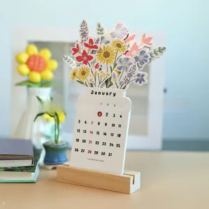 Detail of creative floral desk calendar with premium wooden base on office desk