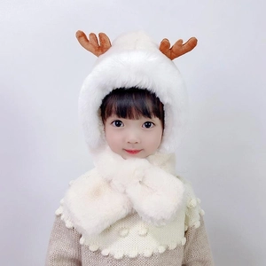 Detail of soft white plush toddler winter hat with cute brown reindeer antlers