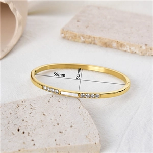 Gold-plated stainless steel oval bangle featuring white shell inlay and zircon crystals