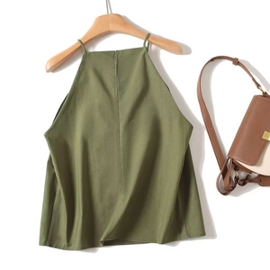 Detail view of army green halter top fabric texture and wood hanger set on white background