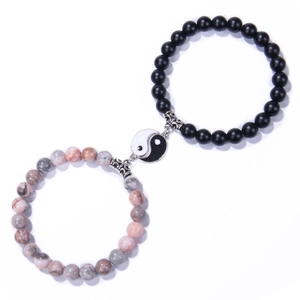 Detail of 8mm matte black and pink natural stone beaded bracelets with Tai Chi pendants