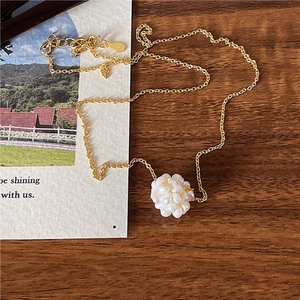 Detail of 925 sterling silver gold necklace featuring white pearl flower cluster pendant