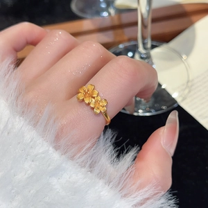 Detail of 24k gold flower ring featuring textured petals and a delicate brushed finish