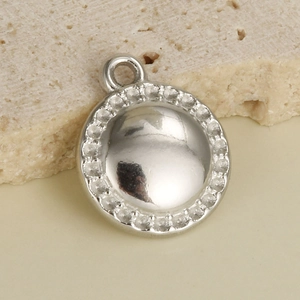 Detailed macro view of a 304 stainless steel silver pendant with beaded edge on stone