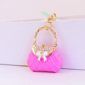 Pink rhinestone handbag keychain with white bow and gold metal diamond pattern finish