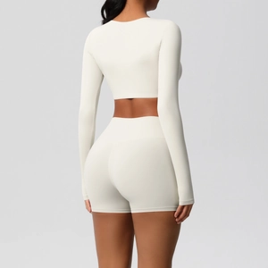 Rear view of cream yoga set showing tight long sleeve top and high waist sports shorts
