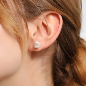 Baroque irregular freshwater pearl earrings in S925 sterling silver worn by a model