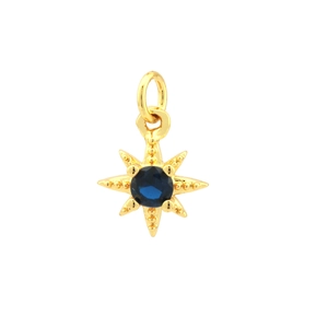 Detailed macro view of 18K gold plated brass star pendant with deep blue zircon stone