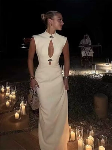 Detail of cut-out neckline with metal buckle on a cream sleeveless maxi dress
