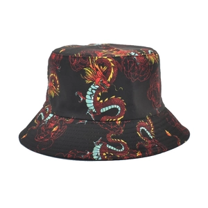 Close-up of vibrant red Chinese dragon and floral prints on a black cotton bucket hat