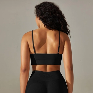 Detail of seamless yoga bra with cross back straps and high-waist compression leggings