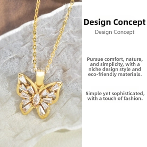 Detail shot of a butterfly pendant with zircon crystals on a delicate gold chain