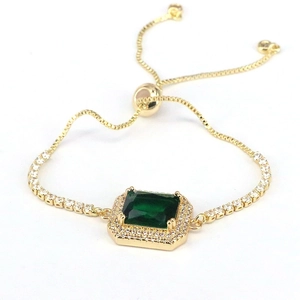 Elegant gold-plated bracelet with emerald cut green zircon and adjustable slider closure
