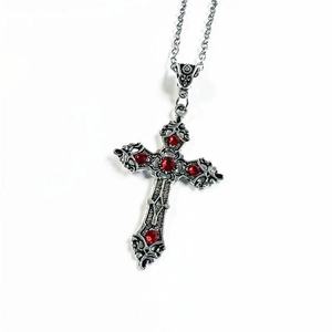 Detail of silver gothic cross pendant with five red gemstones on a simple chain