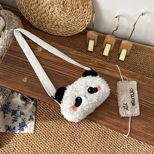 Close-up of white plush panda shoulder bag with soft embroidery and adjustable strap