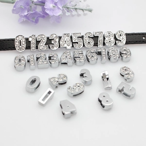 Detail showing 8mm silver alloy rhinestone numbers on a black leather strap for DIY jewelry