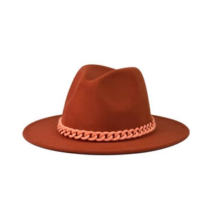 Close-up of rust red fedora hat featuring a stylish pink chain trim decoration
