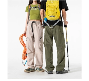 Detail of adjustable buckle belt and tactical side zipper pocket on cargo pants