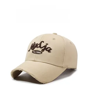 Detail of vintage beige baseball cap with 3D embroidery and distressed brim details
