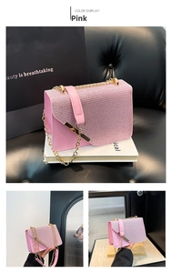 Close-up of pink glitter small square bag with gold chain strap and metal trim details