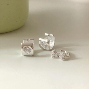 S925 sterling silver heart zircon earrings and bow ear cuff set on a cream background