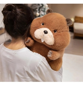 Detailed close-up of a large fluffy brown marmot plush toy held in a cozy home setting