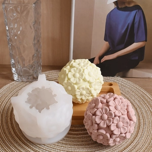 Detailed macro view of 3D flower ball silicone mold with finished floral candle spheres
