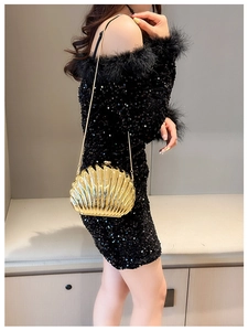 Chic gold shell evening clutch with metallic texture on elegant black sequin dress