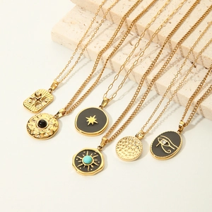 Bohemian gold star and turquoise pendant necklaces on textured stone background