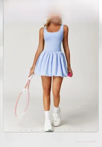 Detail of light blue tennis dress featuring scoop neck and pleated hem with tennis racket