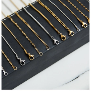 Close-up of titanium steel gold and silver necklace chains with lobster clasps