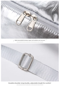 Detail of silver metallic swim bag showing smooth dual zippers and adjustable shoulder straps