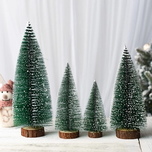 Detailed view of four mini frosted Christmas trees with wooden bases in varying heights