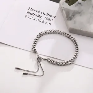 Close-up of a silver dragon bone chain bracelet with an adjustable sliding bead clasp