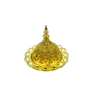 Détail macro du brûle-encens oriental doré avec des motifs ajourés complexes et élégants