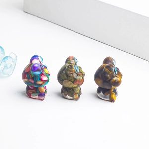 Macro shot of three frog figurines made with natural crystal stones and clear resin