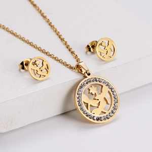 Golden titanium steel dragonfly jewelry set with sparkling rhinestones on stone surface