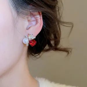 Elegant floral stud earrings featuring red square crystal, white pearl, and marquise zircons